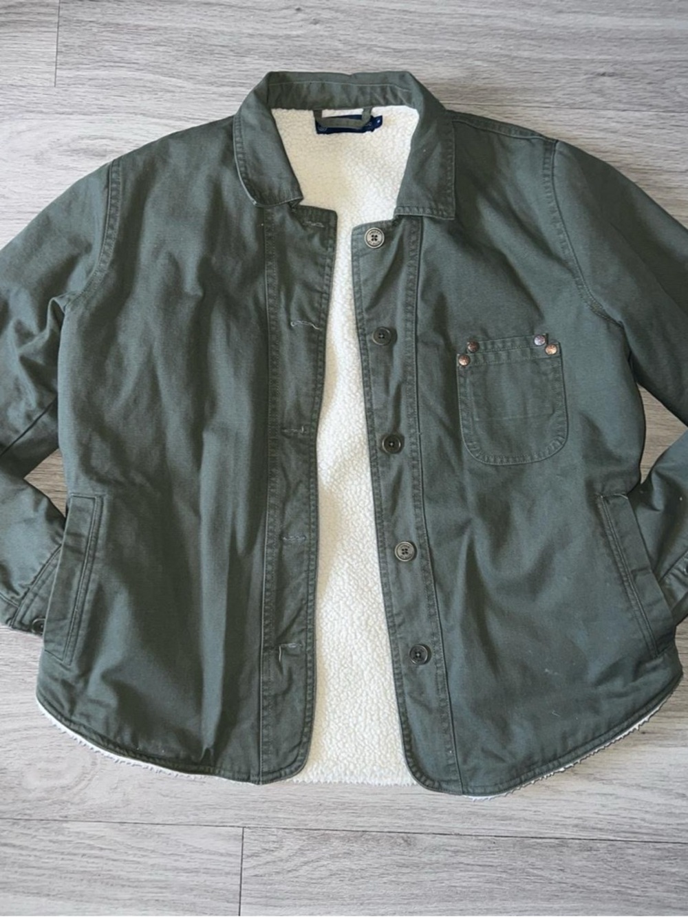 United By Blue green jacket with white sherpa lining and blue tag